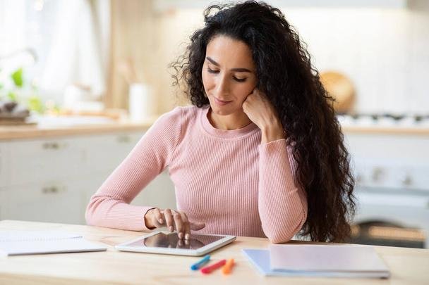 Young Brunette Lady Study With Digital Tablet At Table In Kitchen